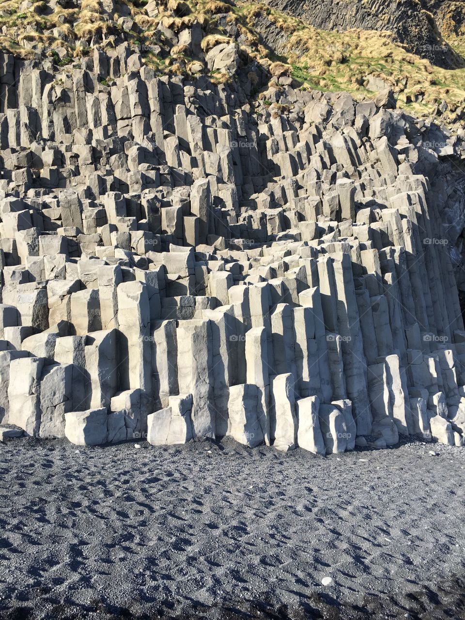 Basalt rock columns on the black sand beach in Vik, Iceland. 