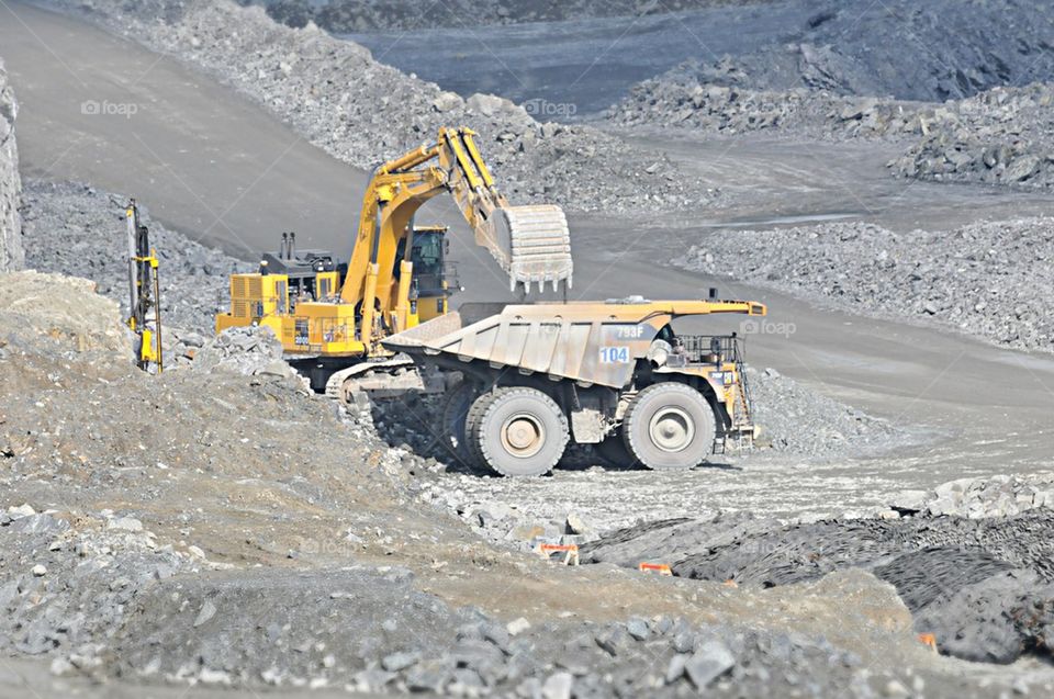 Excavator loading truck