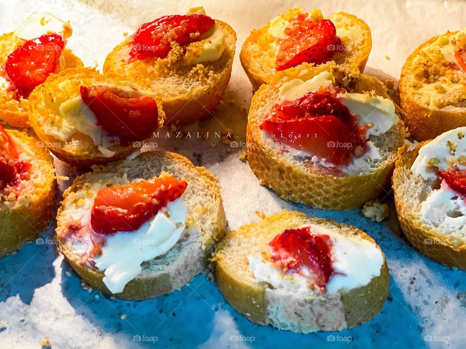 Baguette and strawberry cream cheese on top of it