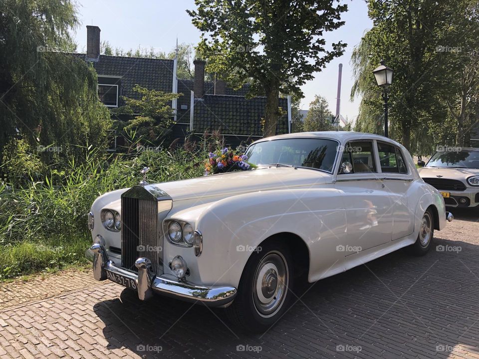Beautiful antique car decorated with flowers and illuminated by the sun