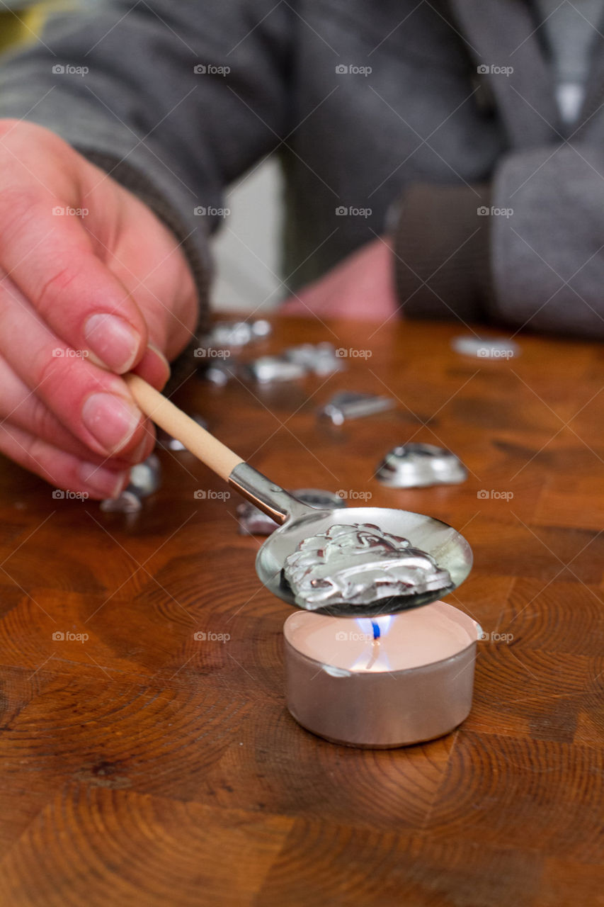 Person performing Bleigiessen german tradition on new year eve