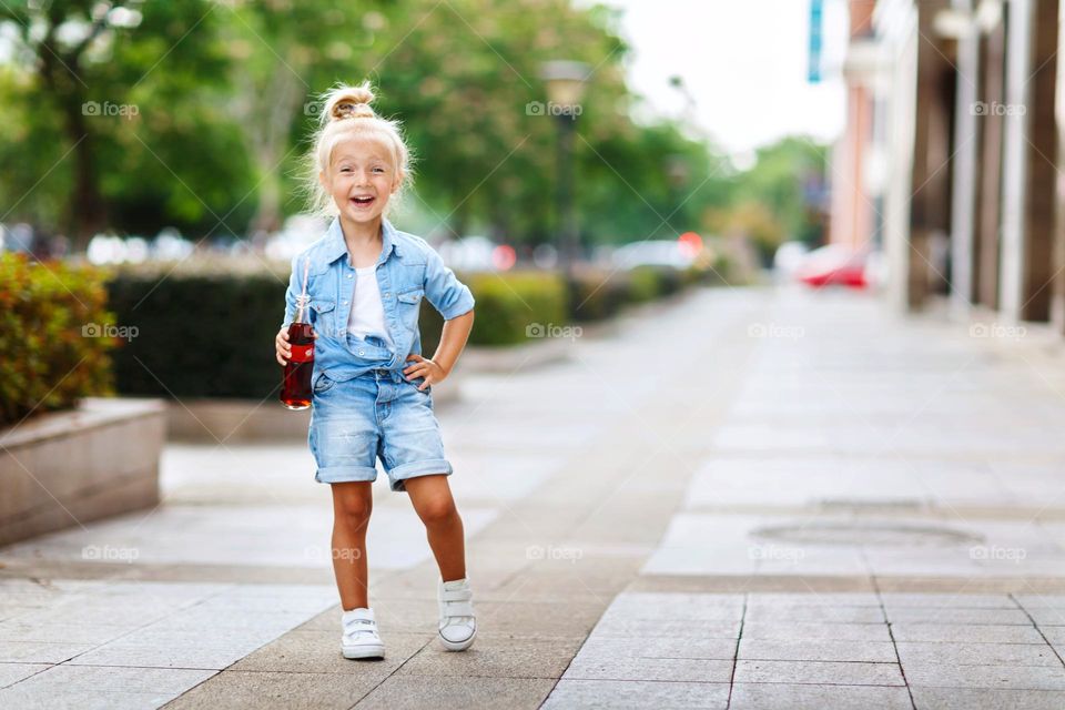 Candid lifestyle portrait of little Caucasian girl outdoor 