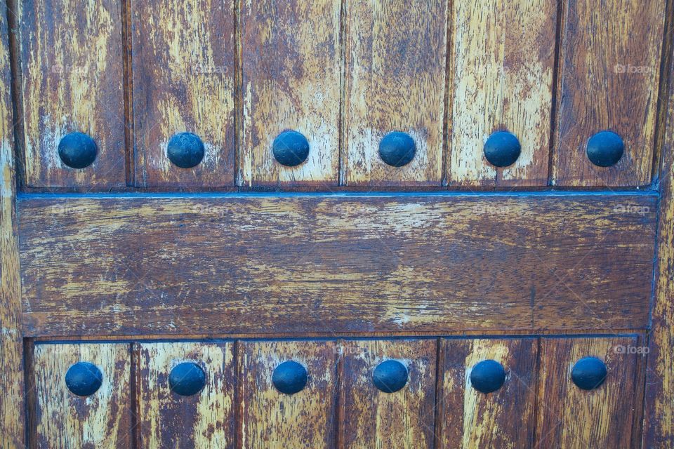 An abstract closeup of an old wooden door in Brooklyn, New York City.