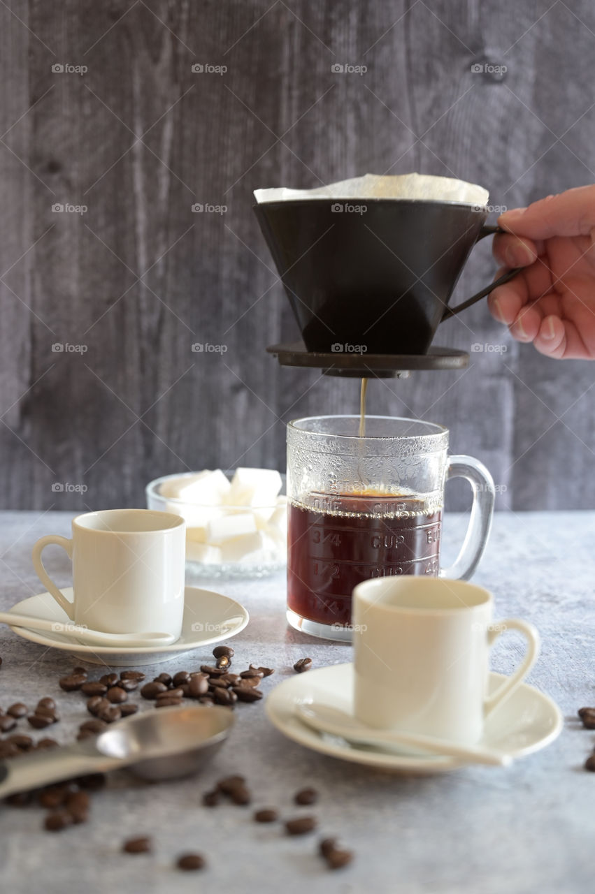 Morning coffee, pour over, hand and shot, natural light, table top.