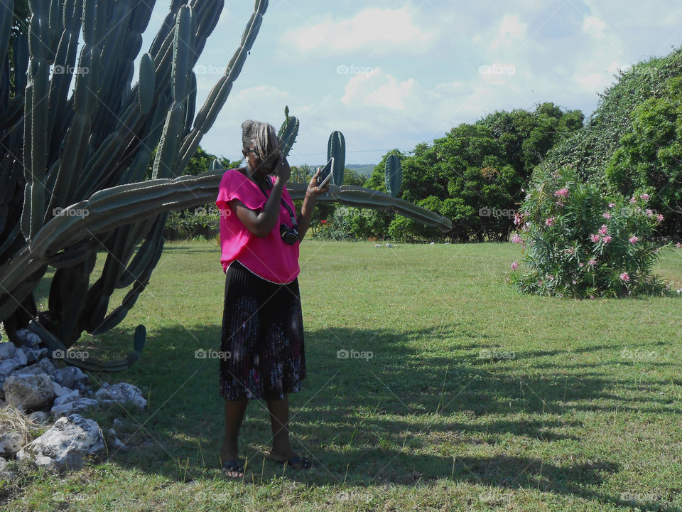 Woman Standing Beside Tree, Talking On Phone