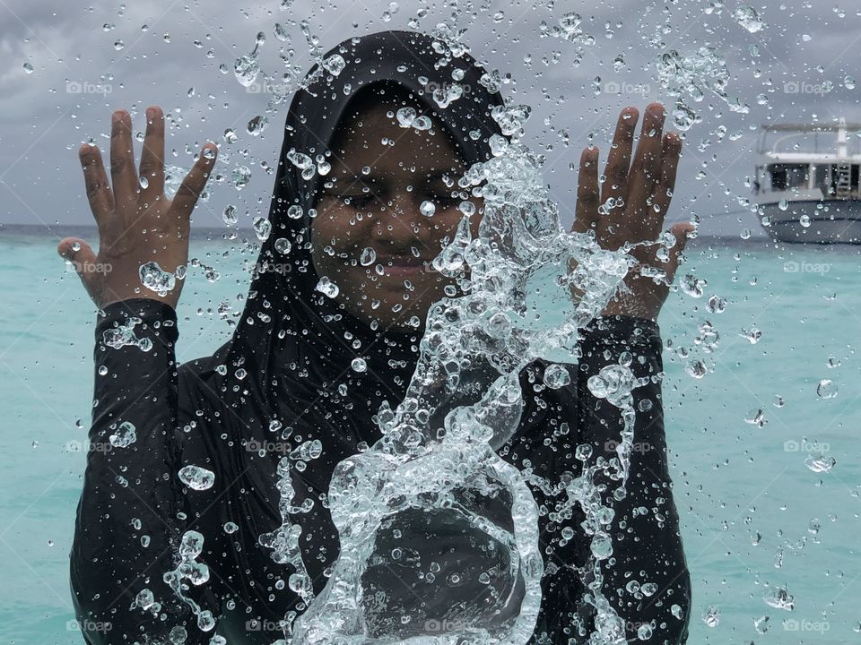 Nice splashing water on a pristine crystal clear lagoon by a girl from sunny side of life. #maldives