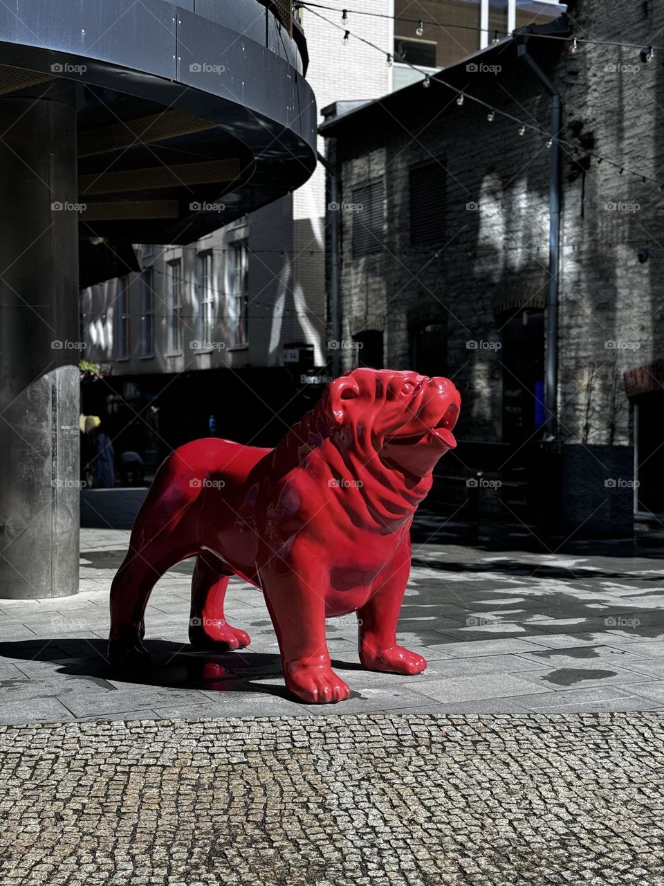 Sculpture of a big red dog on the street 