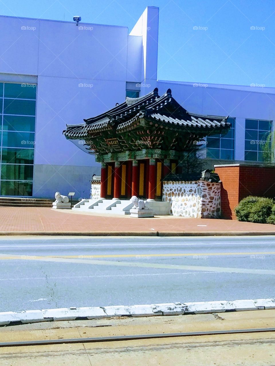 Standing at a bus stop viewing the The Songahm Martial Arts Gate in downtown, Little Rock, Arkansas 