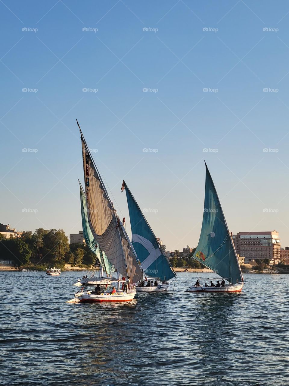 cloudless blue sky boat ride down Nile River along with the felucca in Luxor Egypt