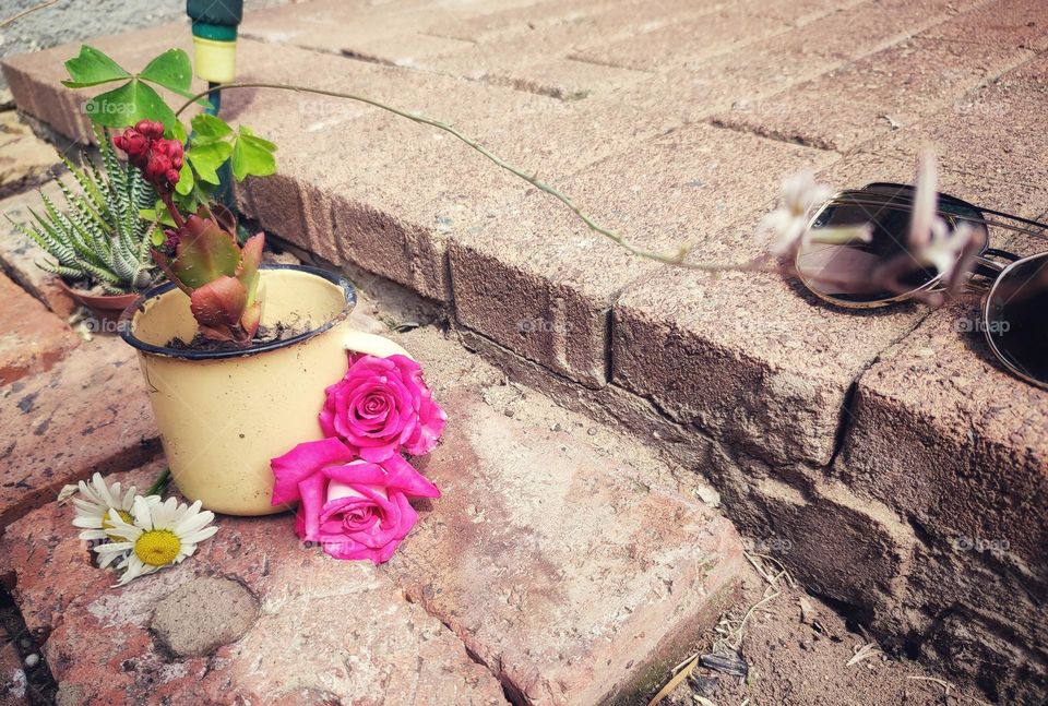 Tin cup with flowers