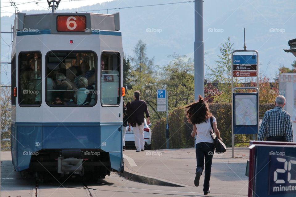 Female Running For A Tram
