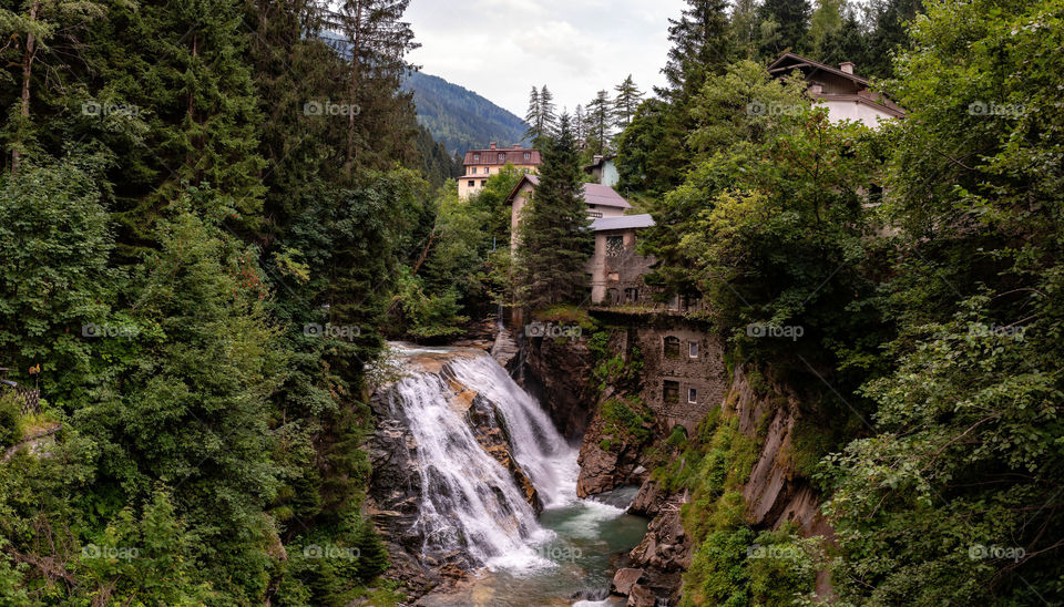view of the mill house and waterfall in the Austrian city Bad Gastein