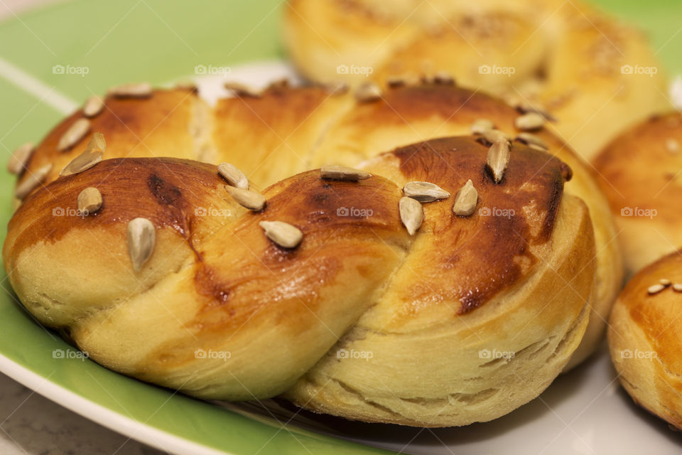 Freshly taken out of the oven sweet homemade pretzels with sunflower seeds topping