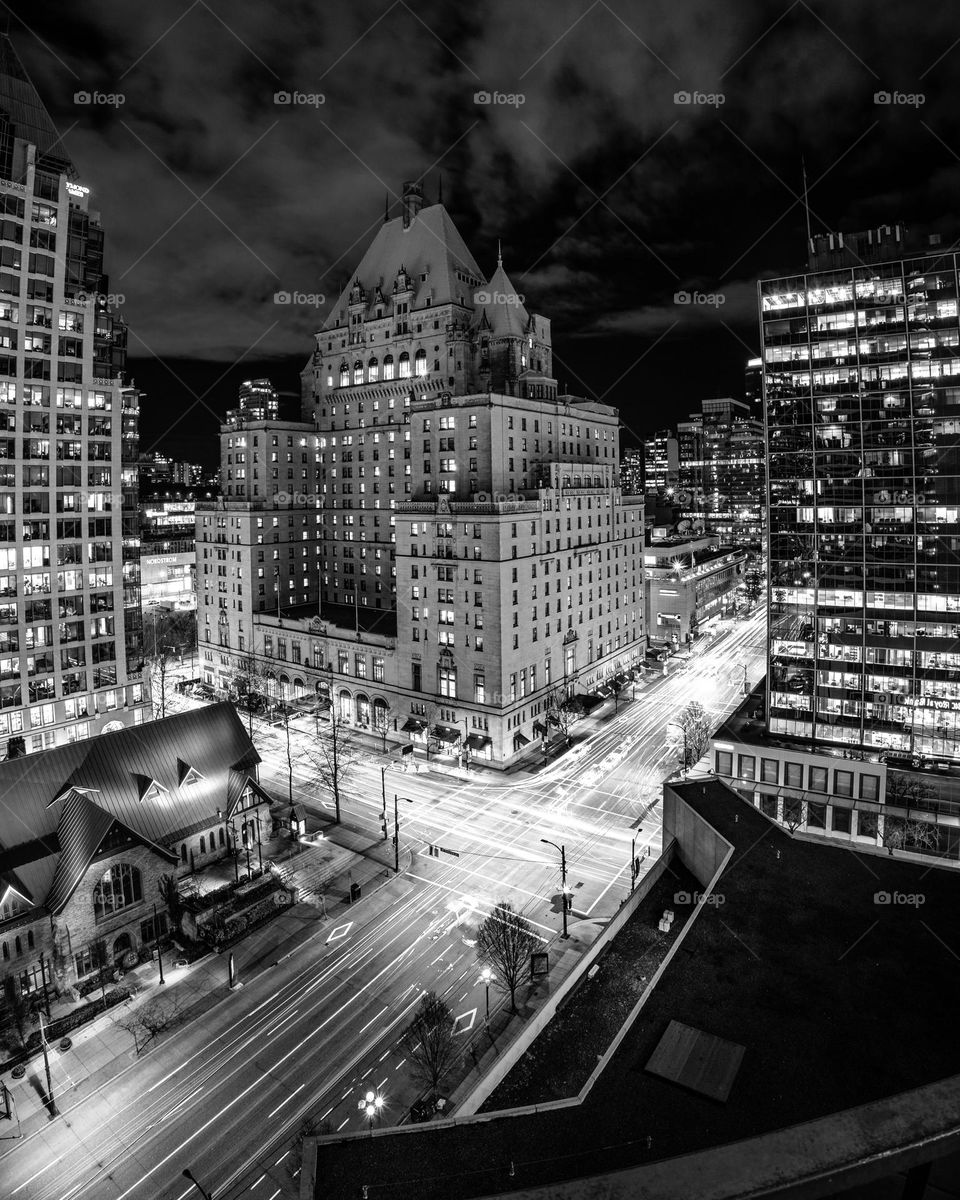 Beautiful old building in black and white with bright light trails from traffic below