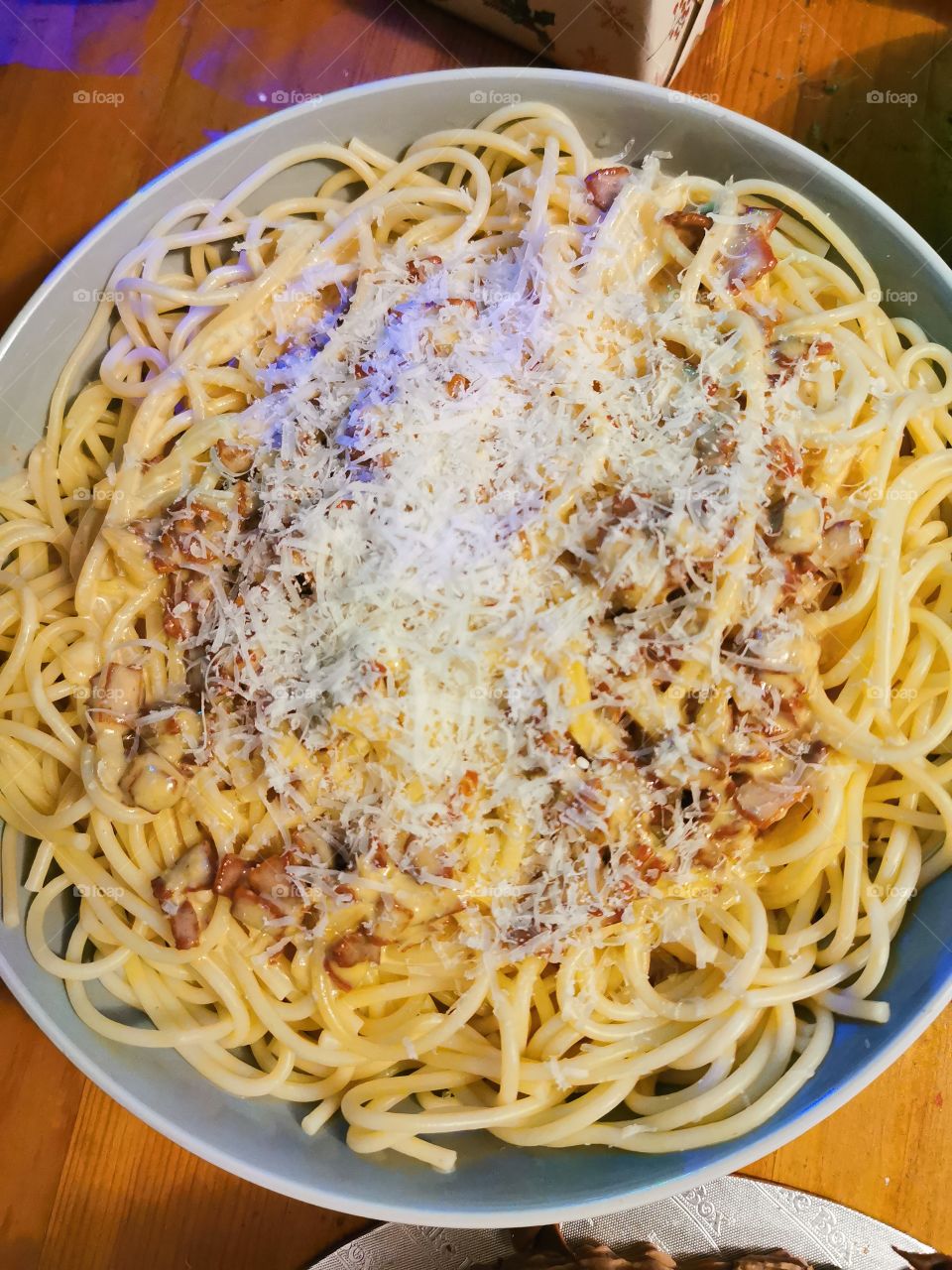Carbonara with crispy pancetta and parmesan on top.