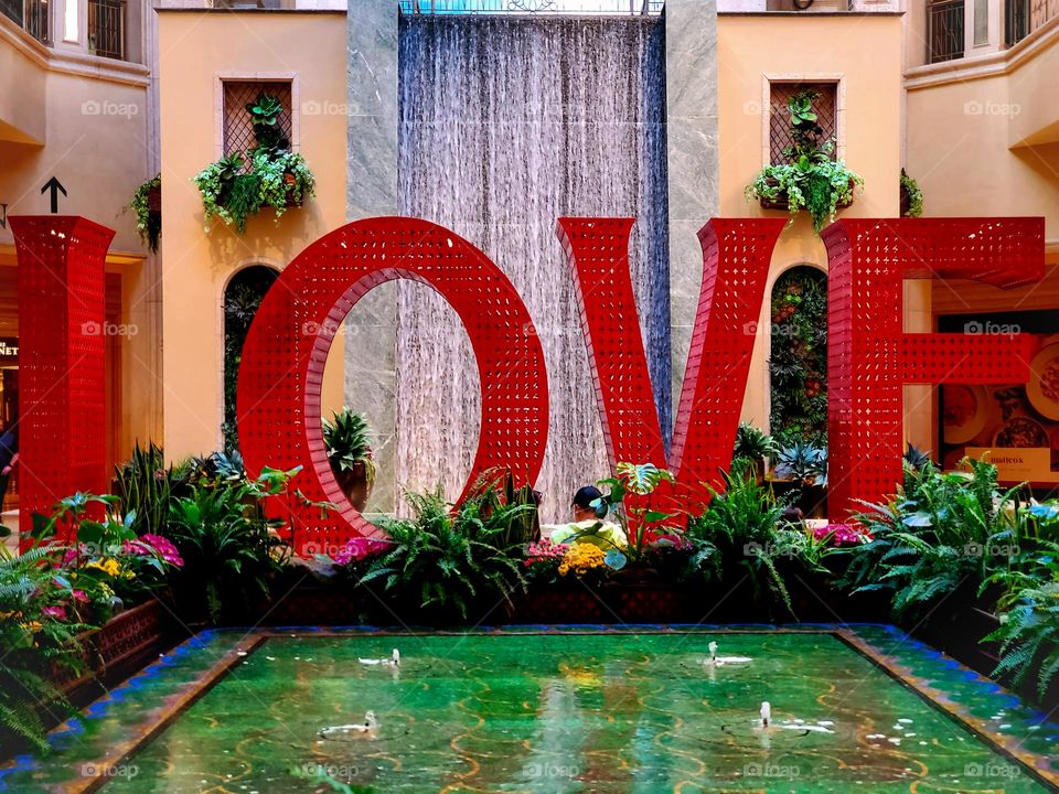 A sign reminds us to love one another, especially in these trying times