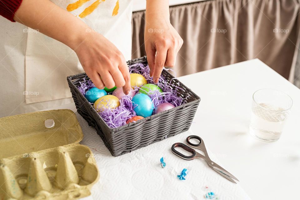 Easter scene woman coloring eggs at home