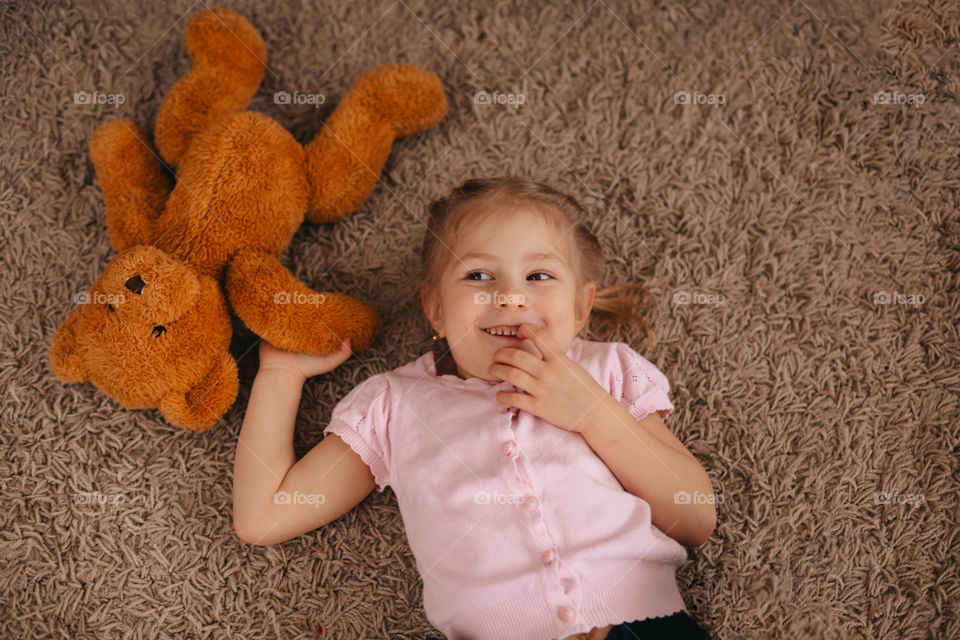 girl playing with a bear