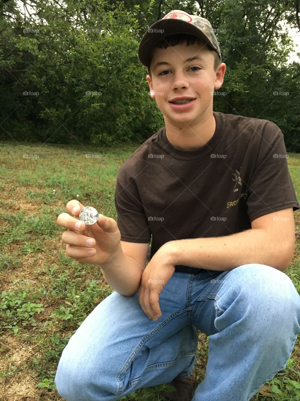 Teenager holding coin in hand