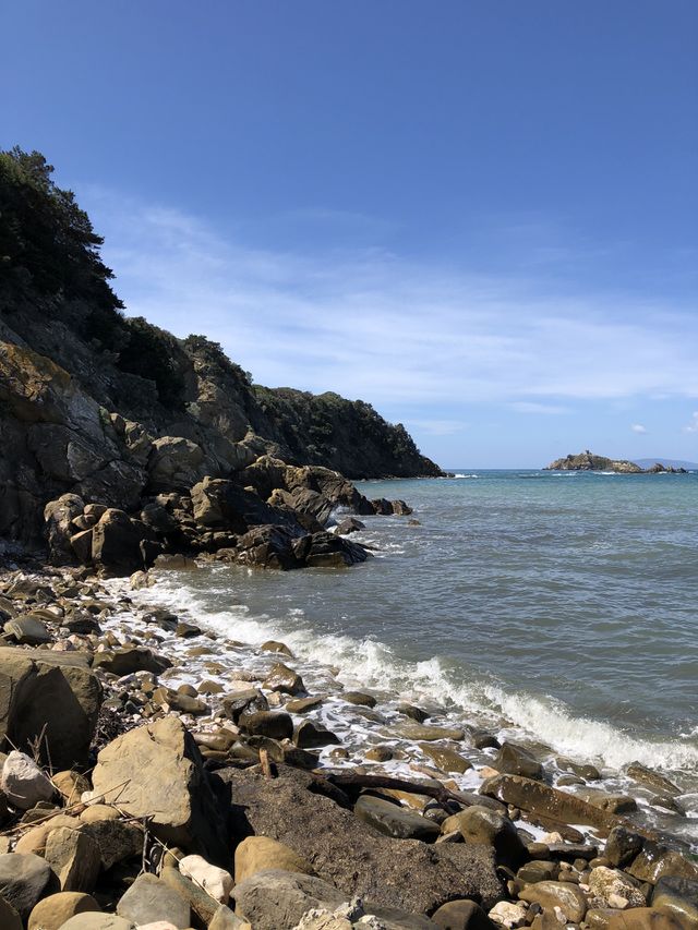 Rocks and stones beach and blue sea and sky 