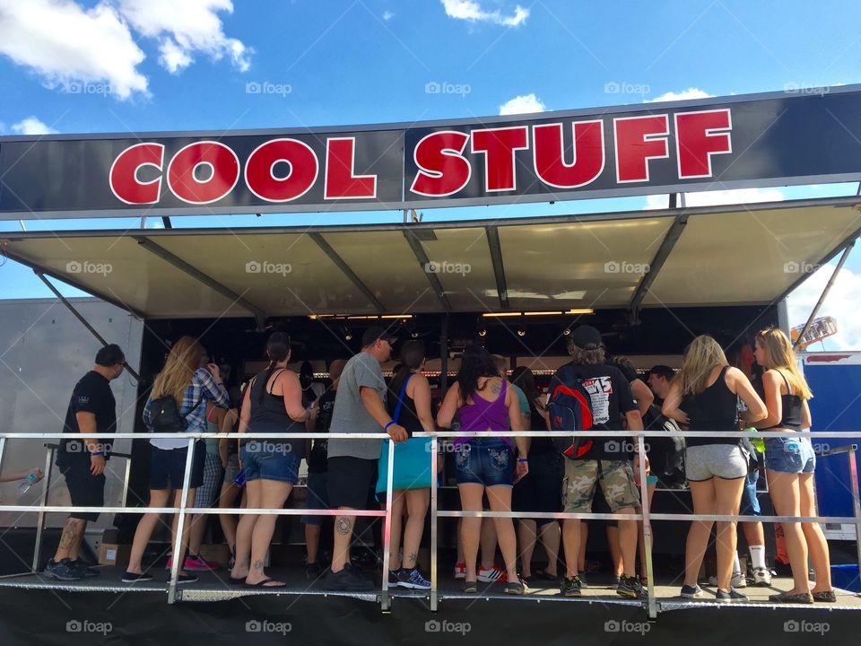 People buying souvenirs at a concert 