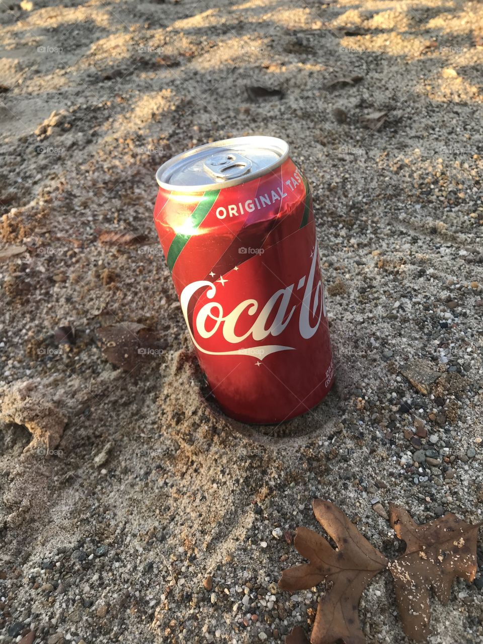 Coca Cola can in the sand 
