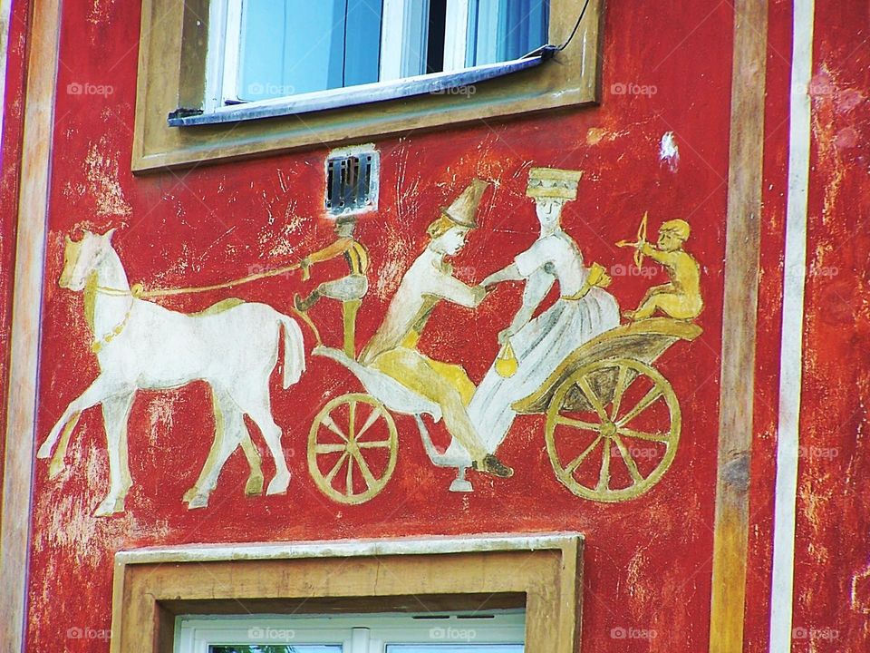 Medieval fresco on side of home in Old Town, Warsaw, Poland; horse and chariot