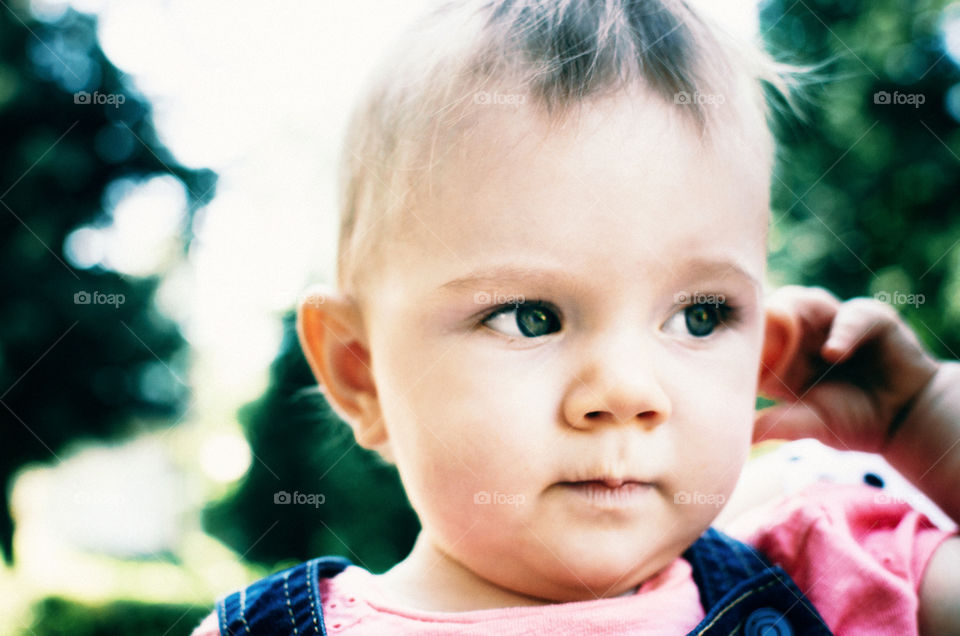 Little baby with a thoughtful face close up