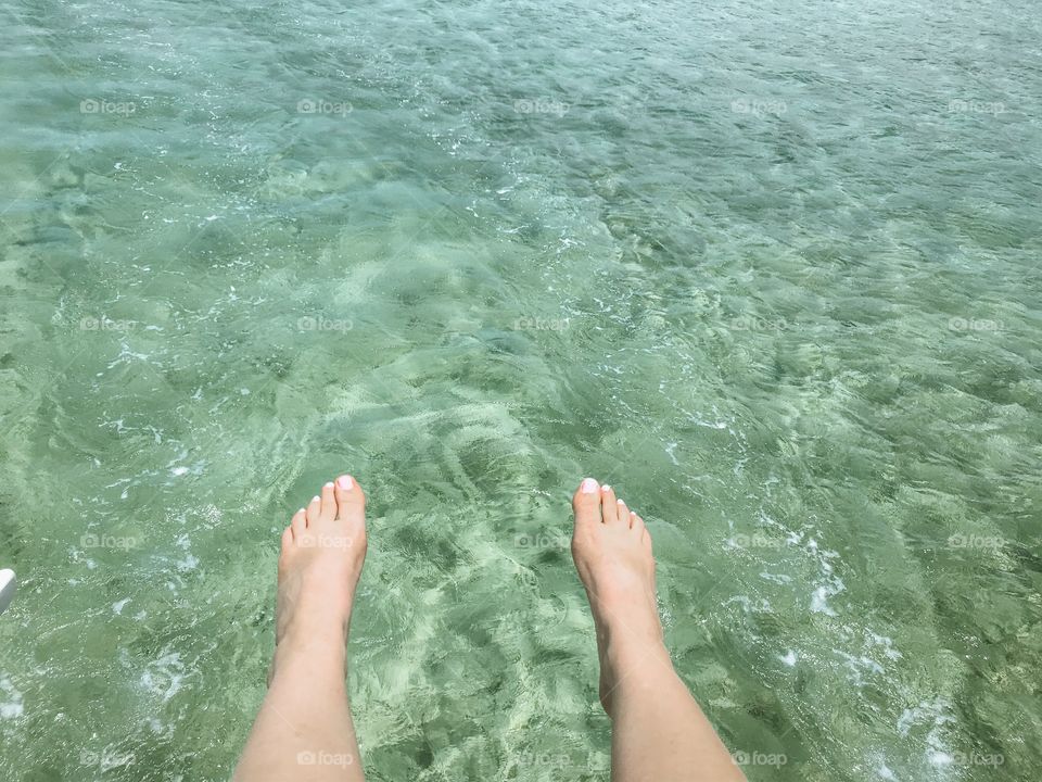 Clear blue ocean water legs