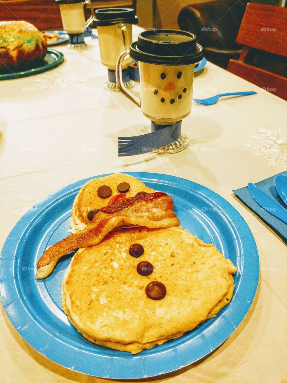 snowman pancakes with a snowman mugs of white hot chocolate