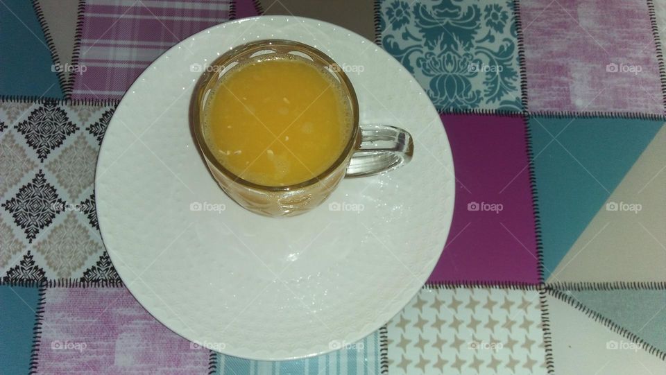 Cup of orange juice.