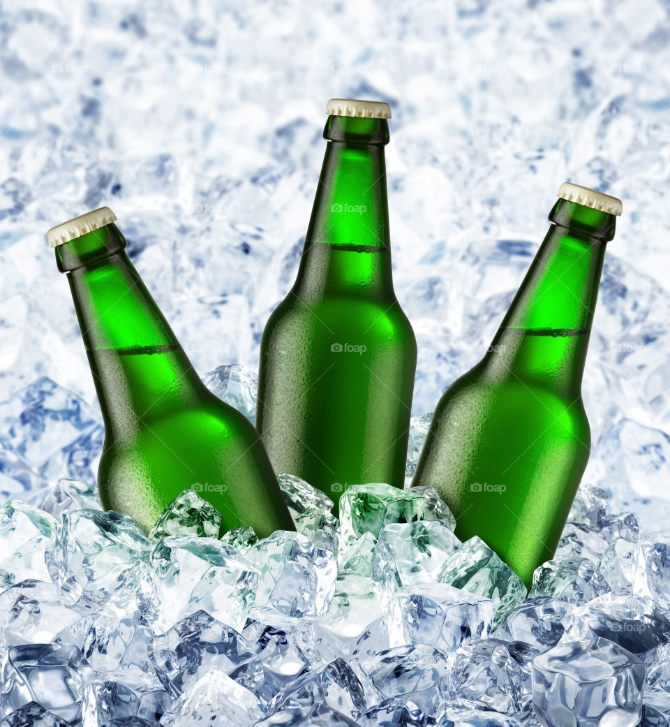 Three beer bottles on ice