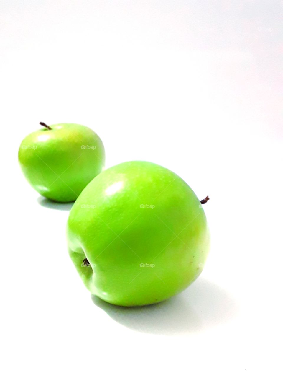 two green apples on a white background