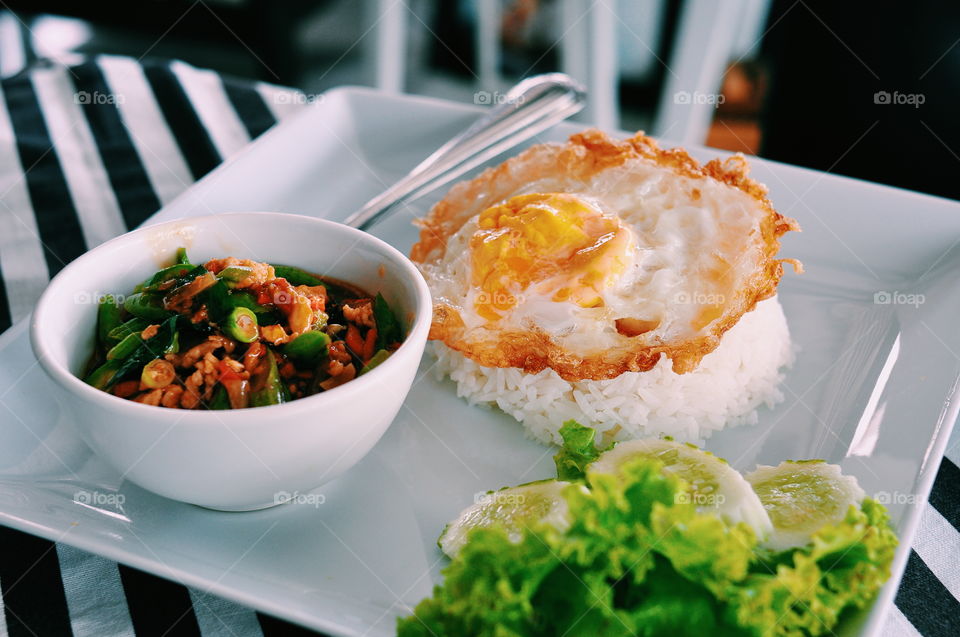 Thai Culture Dish. Sunny side up thai style, rice and stirred fried spicy vegatable with pork. This revolutionary dish is a signature dish throughout the world.