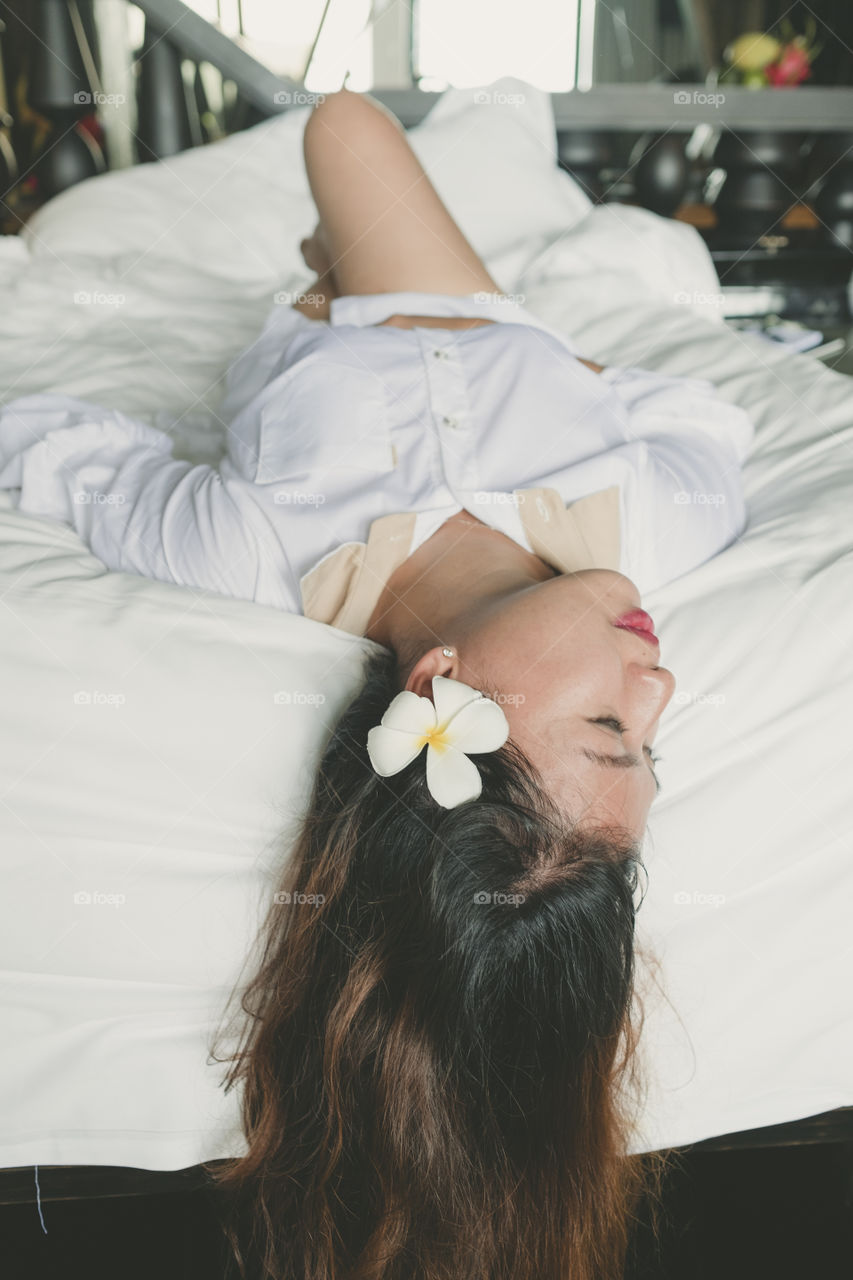 Gorgeous woman lying upside down on bed