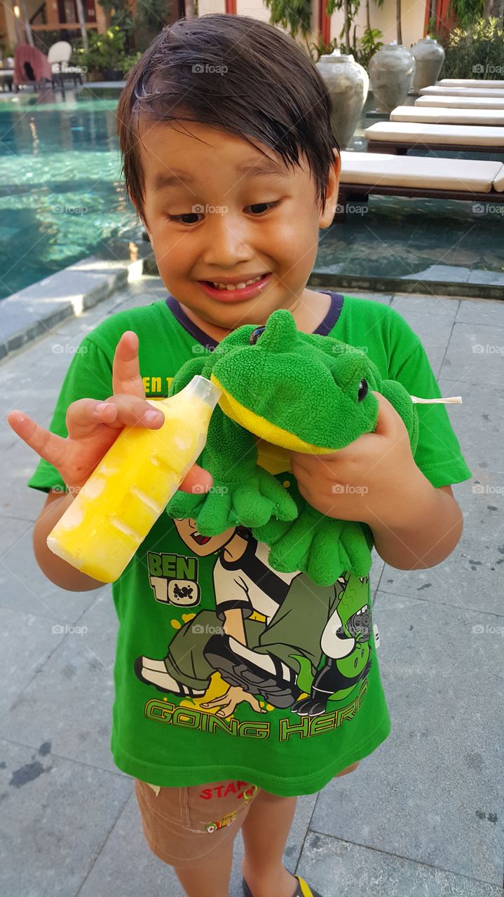 Kid and the frog. boy giving ice cream to is fluffy