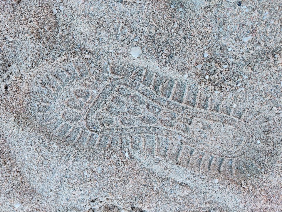 Footprint marks on the sandy beach.