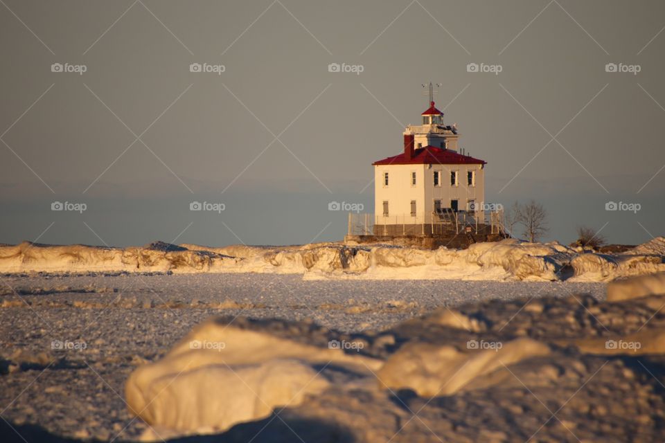 Sunset shining on the Fairport Harbor West Breakwater Lighthouse in Winter, Fairport Harbor, OH  United States
