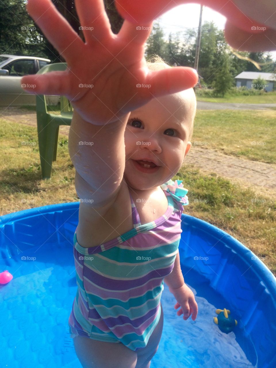 Happy Baby in Pool . Happy baby girl in a kiddie pool.