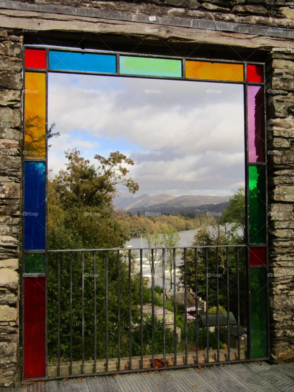 View accross windermere with the bright and cheery stained glass window frame