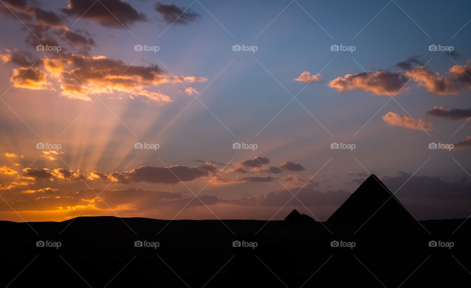 Sunset light beam on Pyramid background 