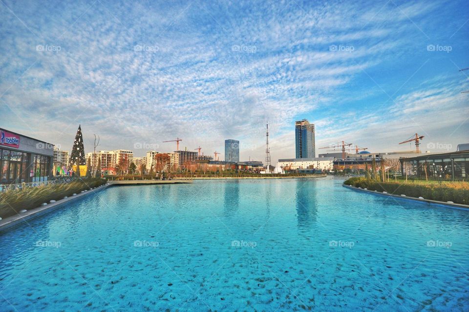 beautiful beautiful blue water in the background city under construction with skyscrapers