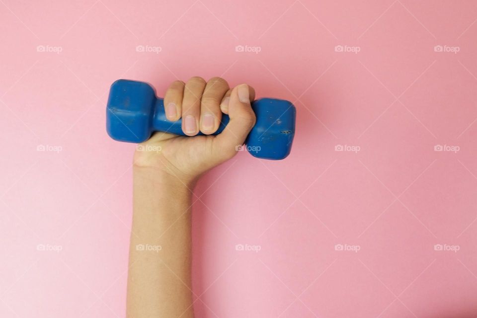 Dumbbell in hand. Gymnastics equipment. Exercises to exercise the arm