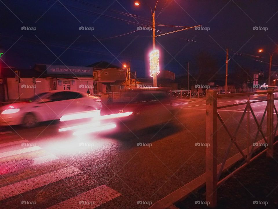 the movement of cars on the highway in the city at night