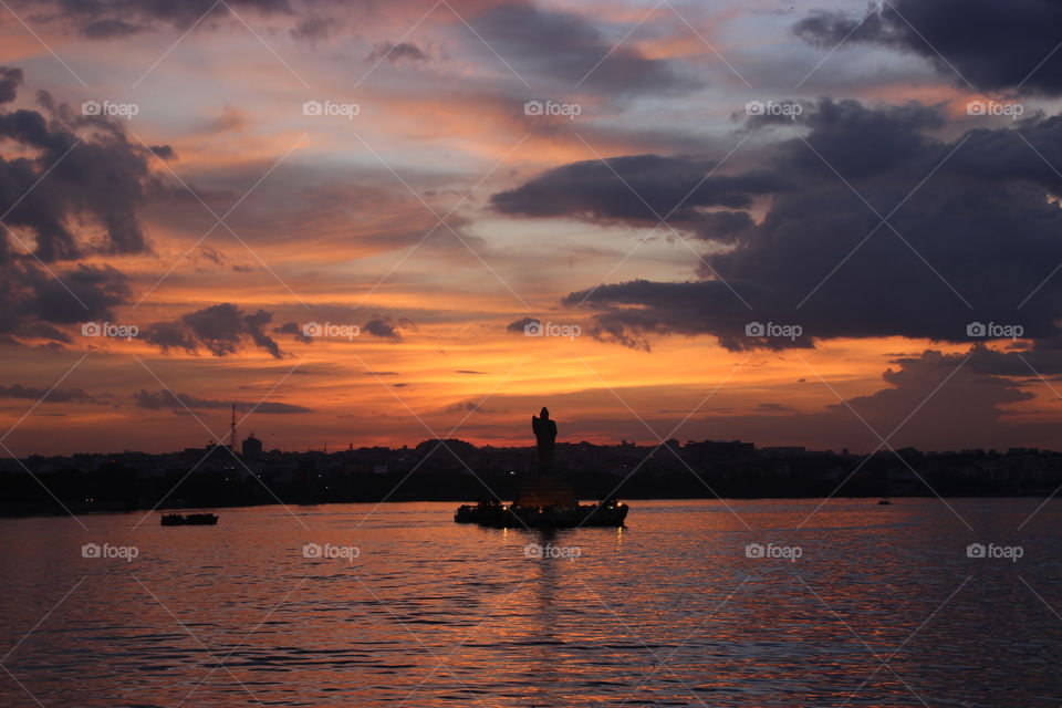 Gautham buddha statue and sunset at lake