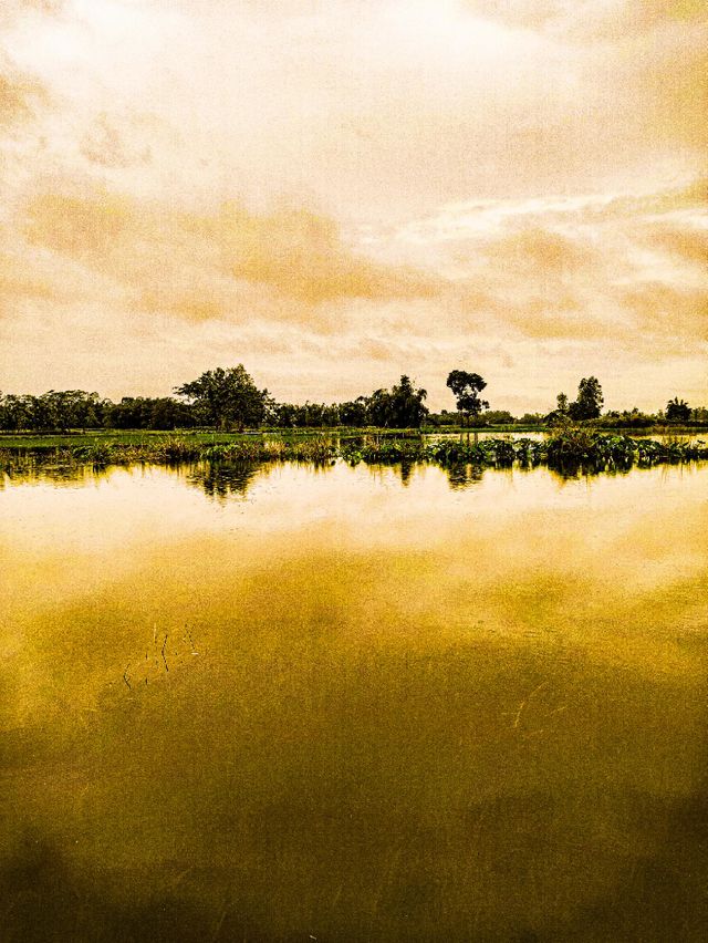 I took this photo myself.  There is water in the river and clouds in the sky.  This landscape looks very beautiful.  This river of our village is very beautiful.