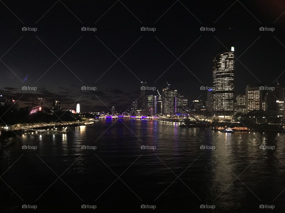 Brisbane city at night over water