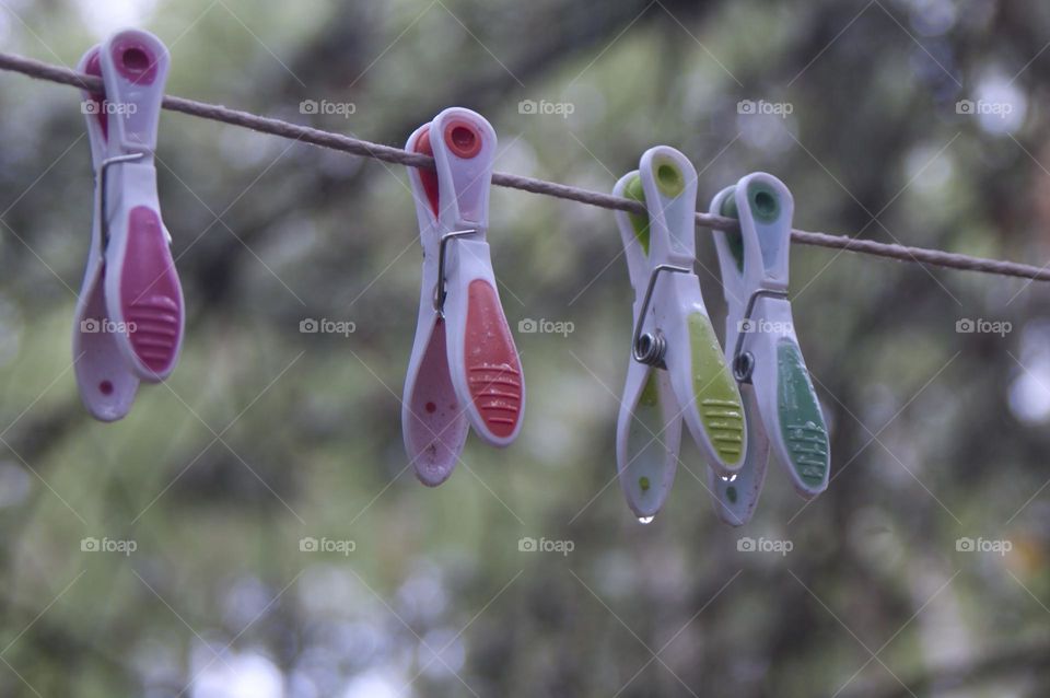 clothespins hang on a rope and clean linen is dried