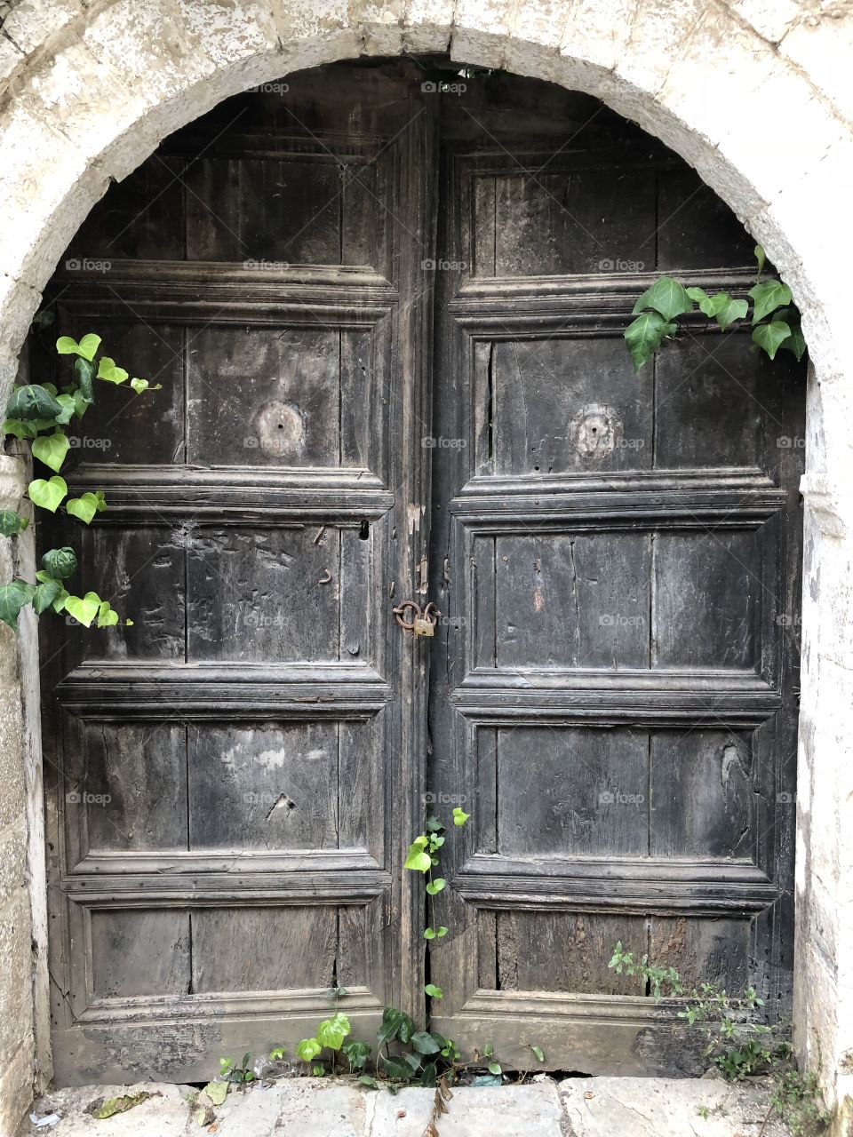 An old door in an narrow alley of the old town Berat in Albania. 