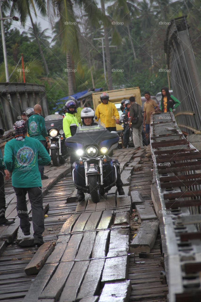 Convoys of motorbike riders pass through extreme bridges in Palu, Central Sulawesi. This moment became a spectacle of local residents